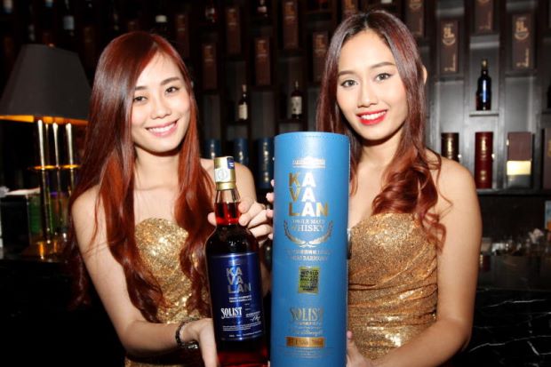 Models holding the Kavalan Solist Vinho Barrique which was named the World's Best Single Malt Whisky for 2015 in the World Whiskies Award.